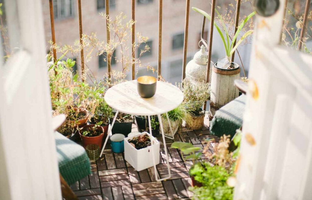 Einen-Balkon-mit-Blumen und Pflanzen und einem runden Tisch