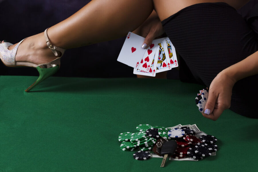 Woman holding cards and poker chips
