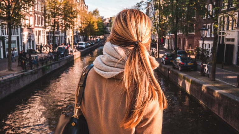 Woman stood over canal in Amsterdam