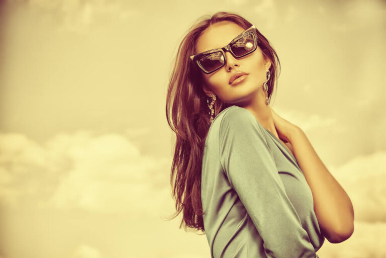 Woman wearing grey top and sunglasses