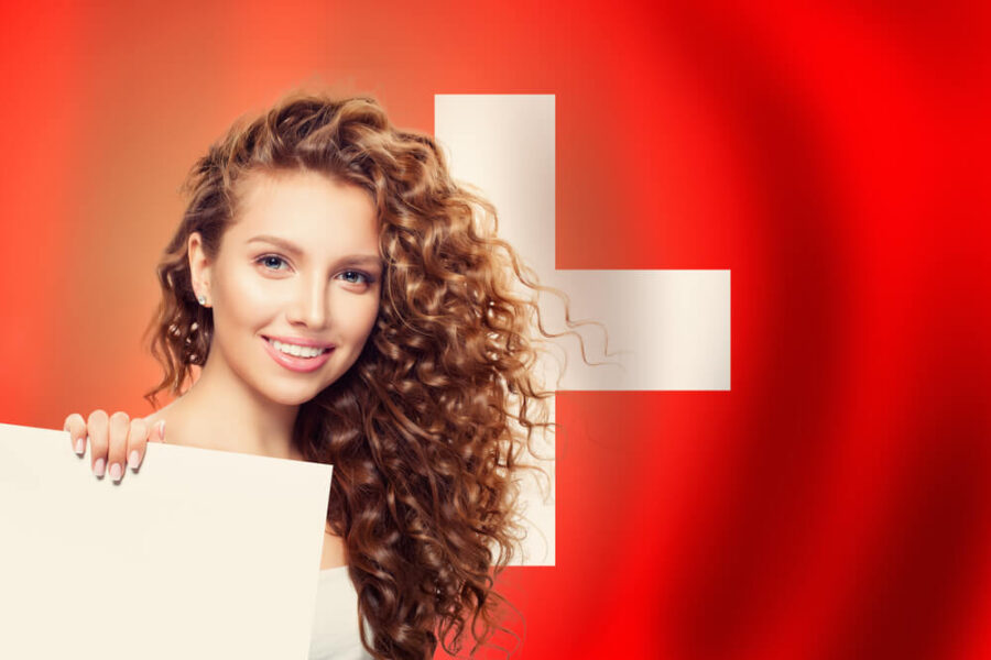 Woman in front of the flag of Switzerland